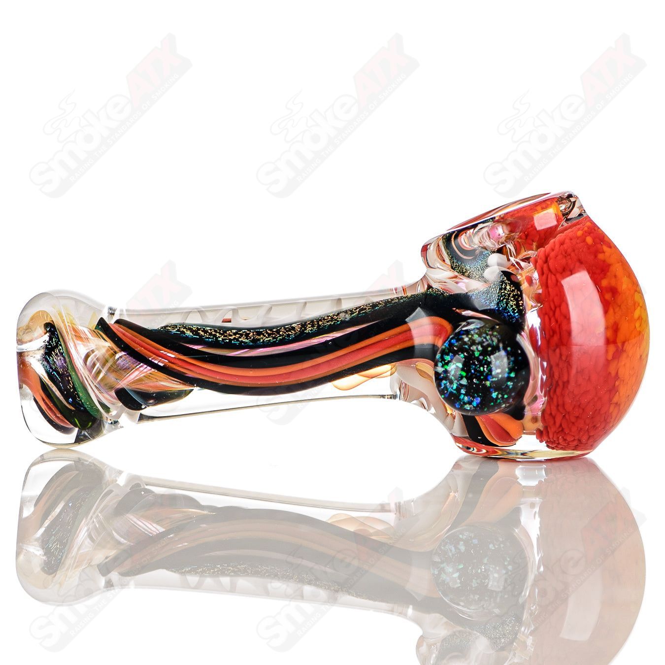 Color-worked IO spoon hand pipe by Jeremy from Oregon featuring vibrant, artistic glasswork in a compact, ergonomic design.