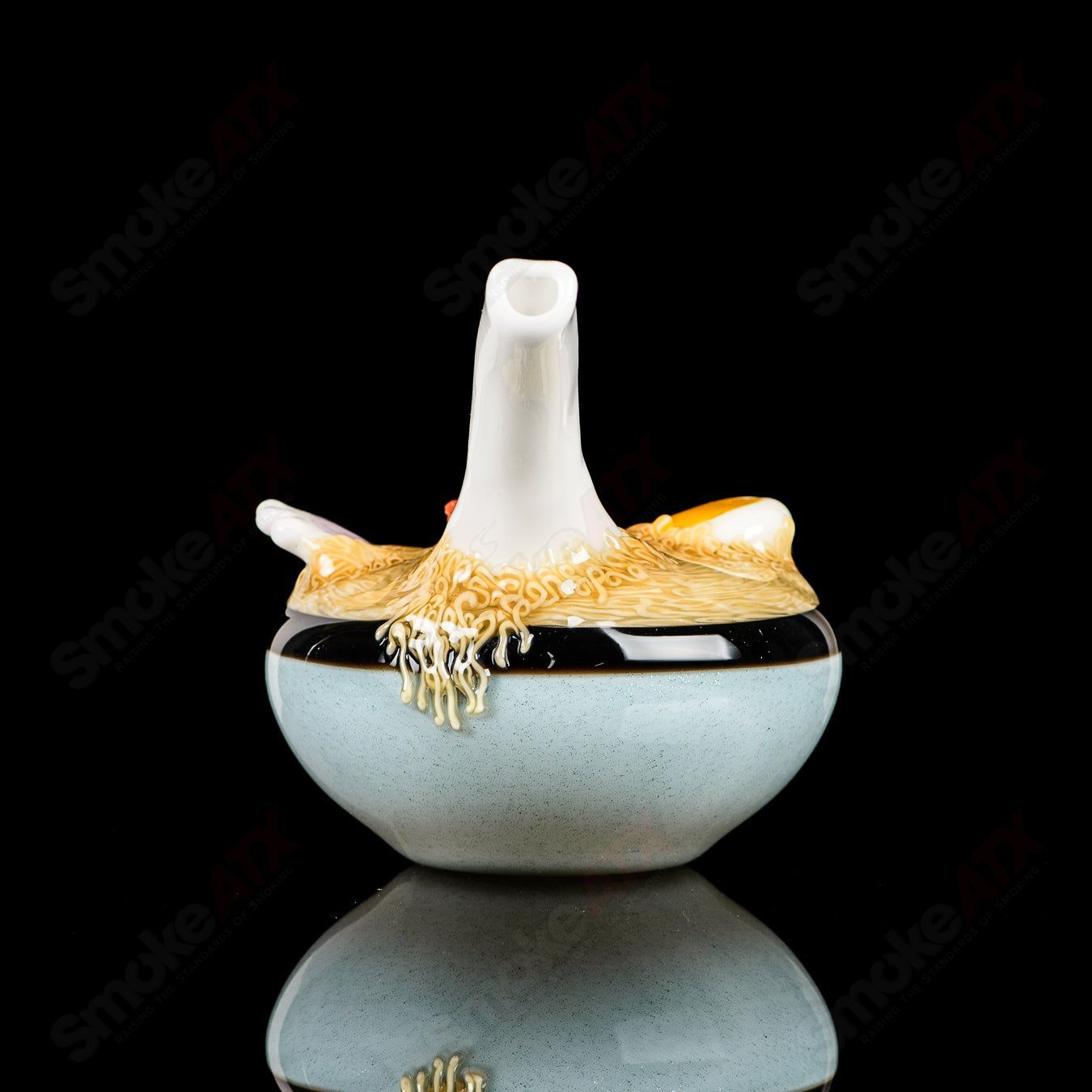 Dojo Glass Ramen Rig, a clear heady glass concentrate rig with intricate ramen bowl design and colorful accents.