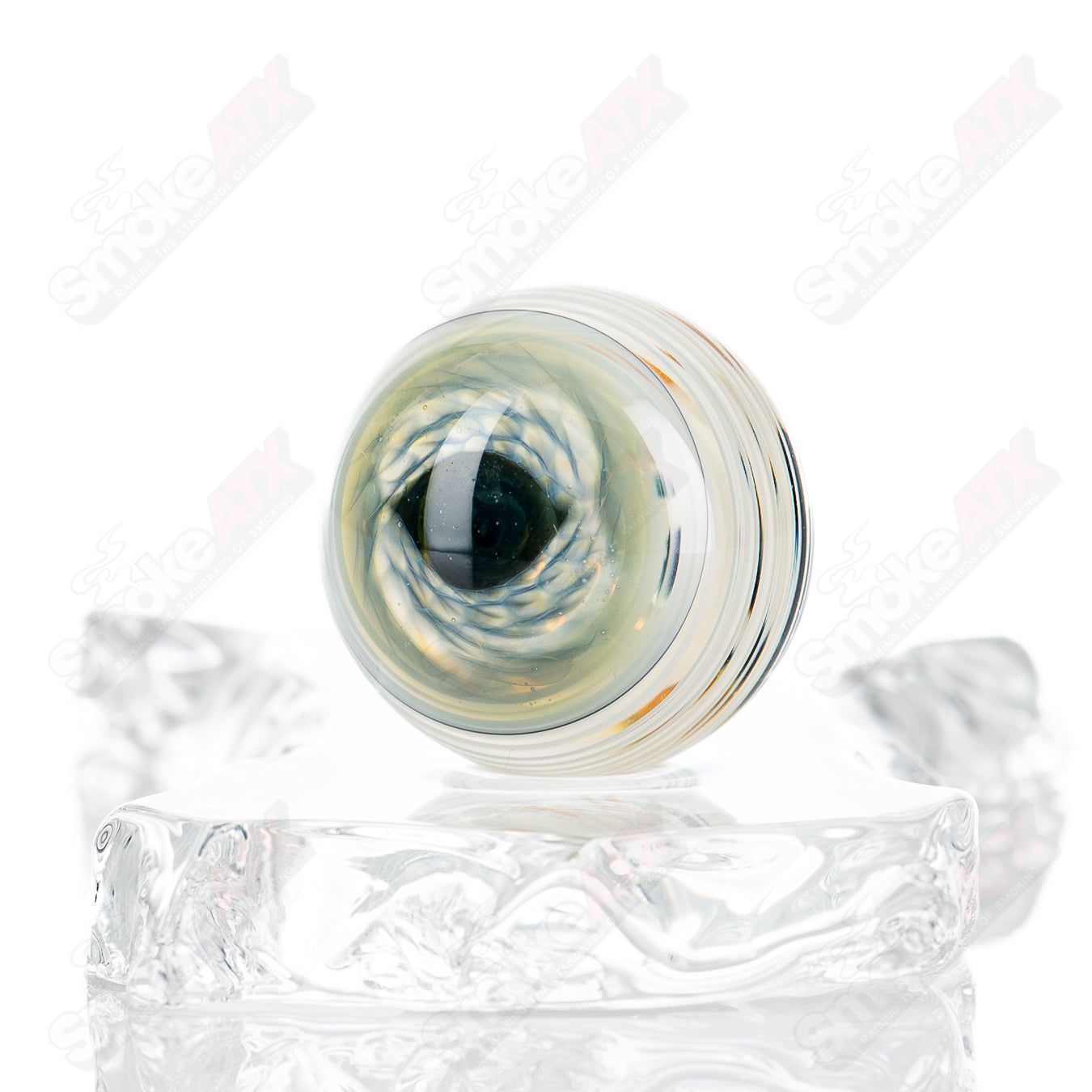 Glass heady pipe featuring a skull and eye design with colorful marbles, made by Indo Glass.