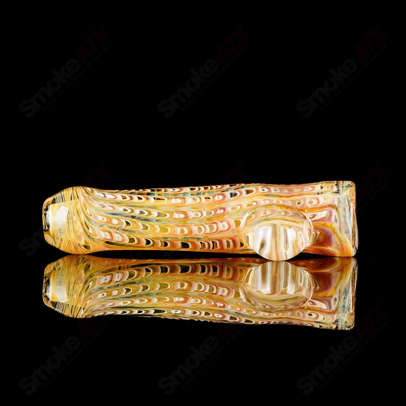 Transparent worked JMK Glass chillum with clear dot signature, showcasing intricate glasswork and smooth glass texture.