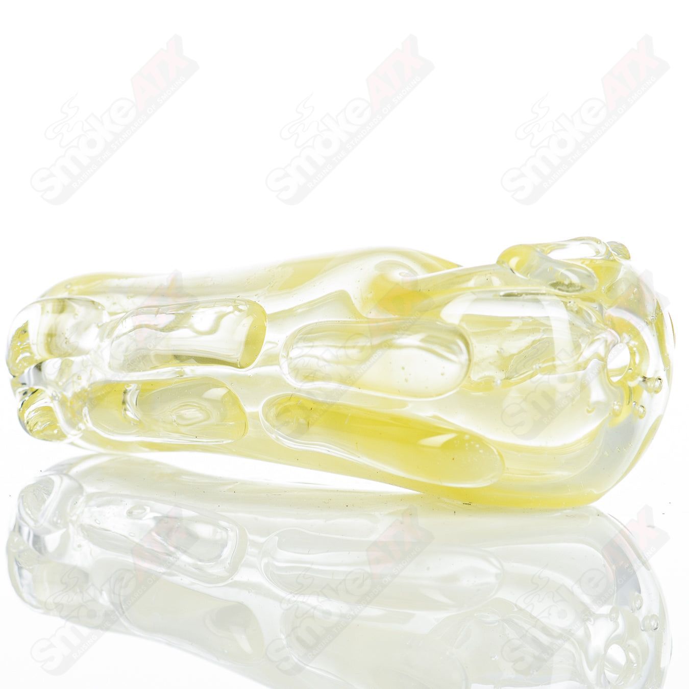 Clear glass spoon pipe by Nobody, featuring a smooth bowl and elongated stem, designed for easy handling and use.