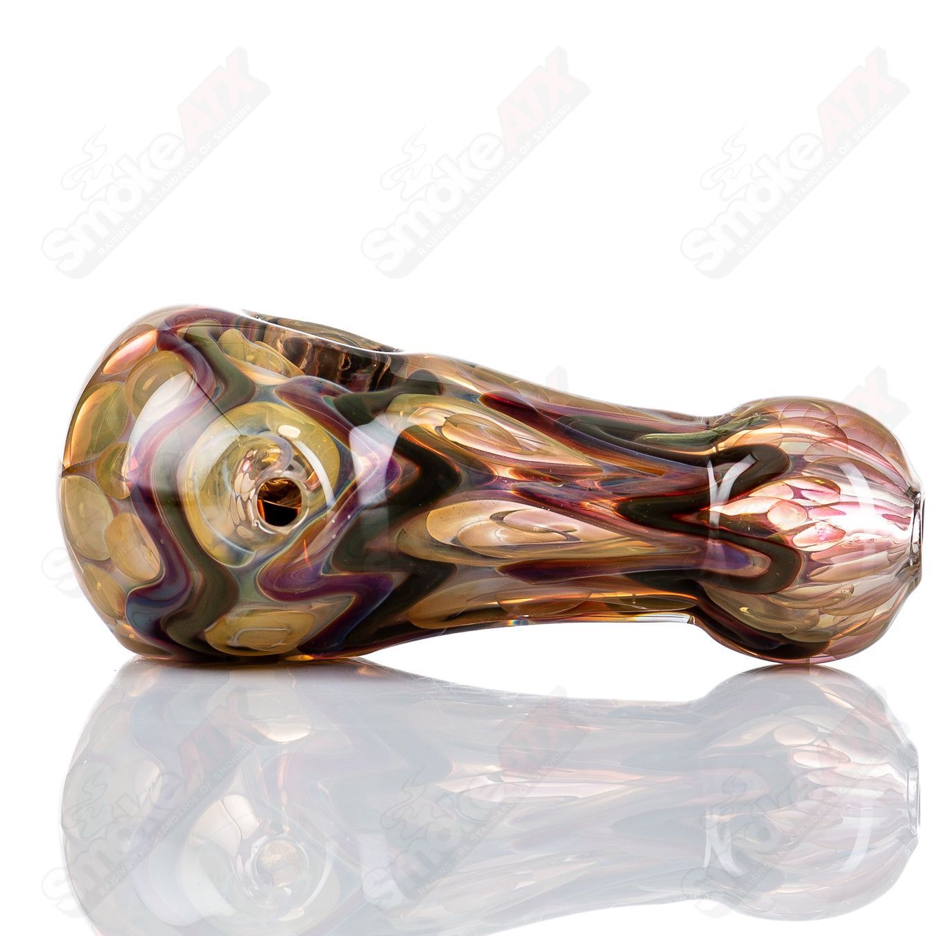 Glass pipe by Shane Smith featuring gold and silver fume designs, in a sleek spoon shape.