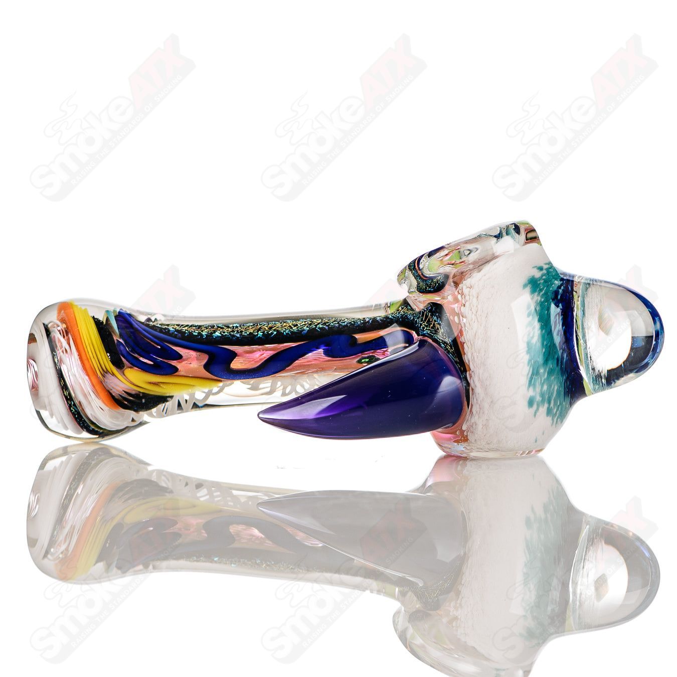 Colorfully worked IO spoon hand pipe by Jeremy from Oregon, featuring intricate 16-color glass design and smooth rounded shape.