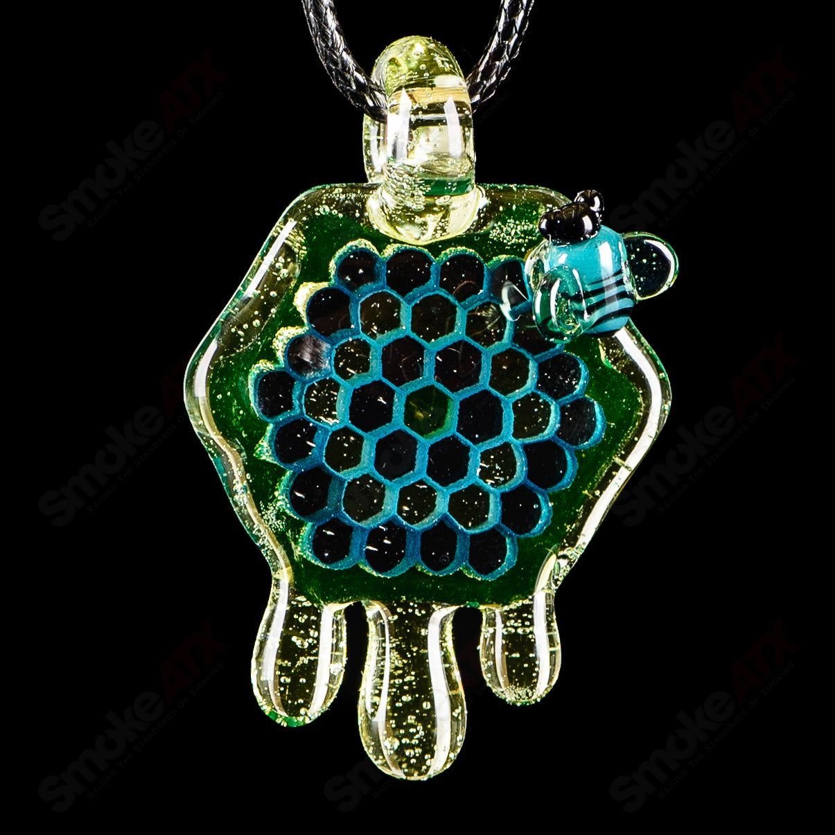 Joe P Glass 2-inch honeycomb drip pendant in teal, UV green, and yellow, featuring vibrant heady glass design.