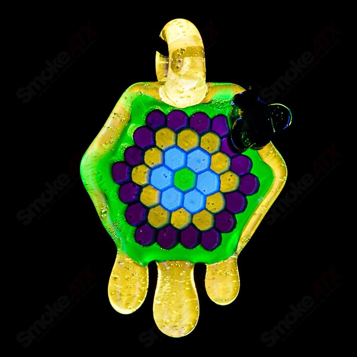 Joe P Glass 2-inch honeycomb drip pendant in teal, UV green, and yellow, featuring colorful heady glass design.