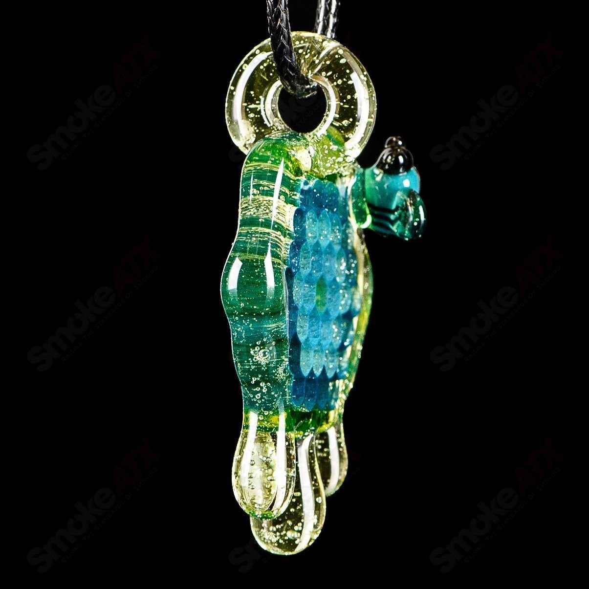 Joe P Glass 2-inch honeycomb drip pendant in teal, UV green, and yellow with colorful heady glass design.