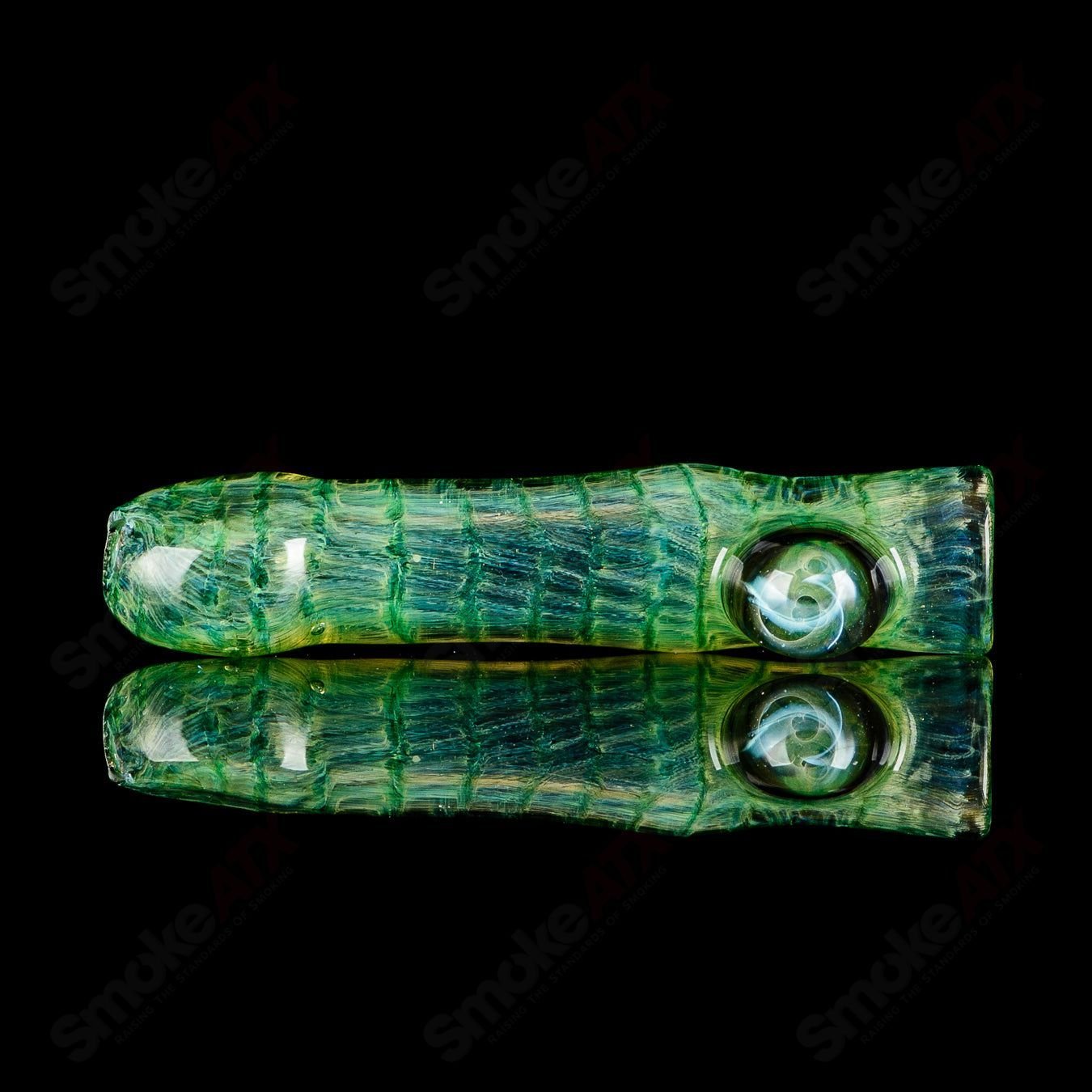 Signed JMK Glass #2 I/O Worked Chillum, clear glass pipe with intricate worked design and signature detail.