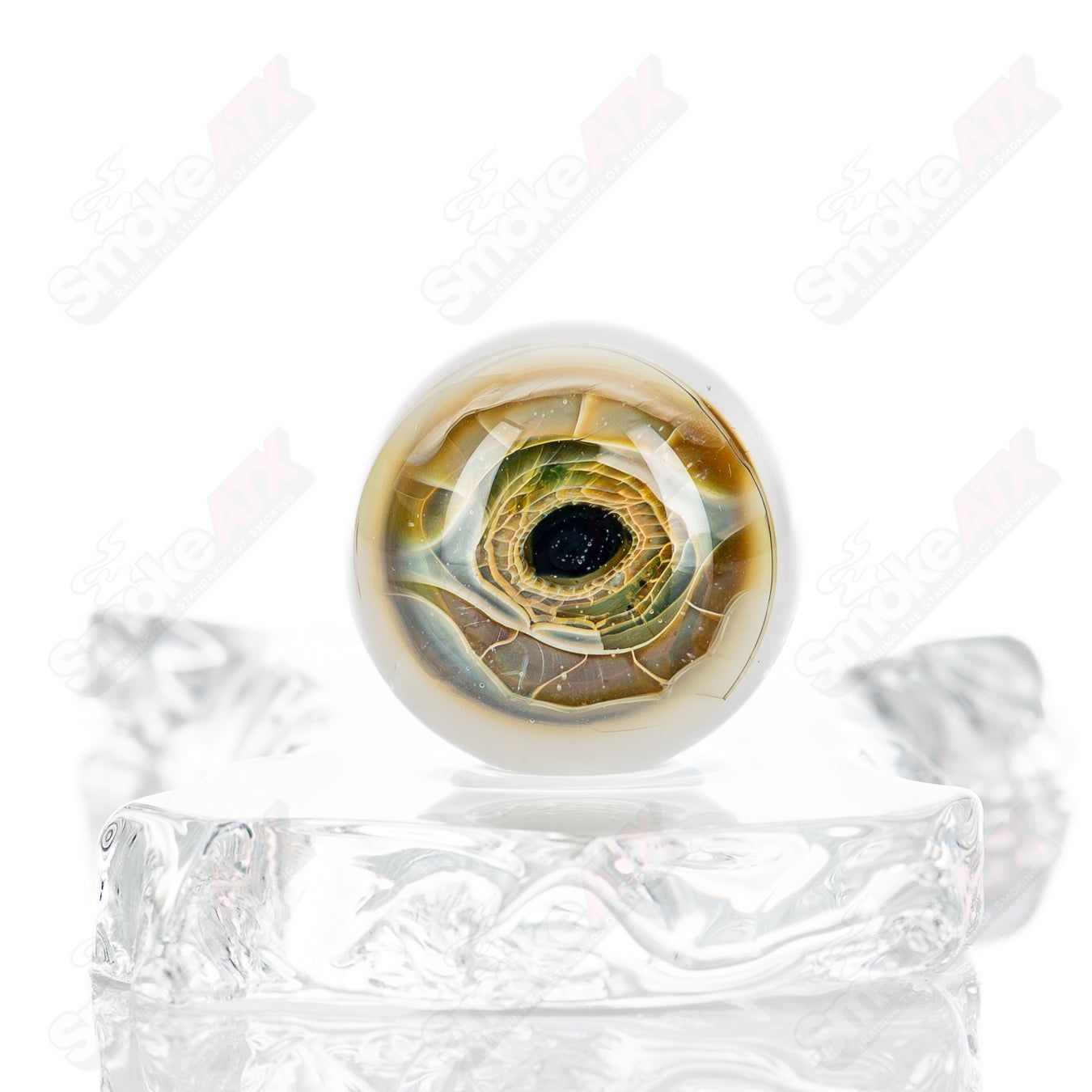 Colorful Indo Glass heady glass with skull and eye design, featuring marbles and intricate details, showcasing craftsmanship.