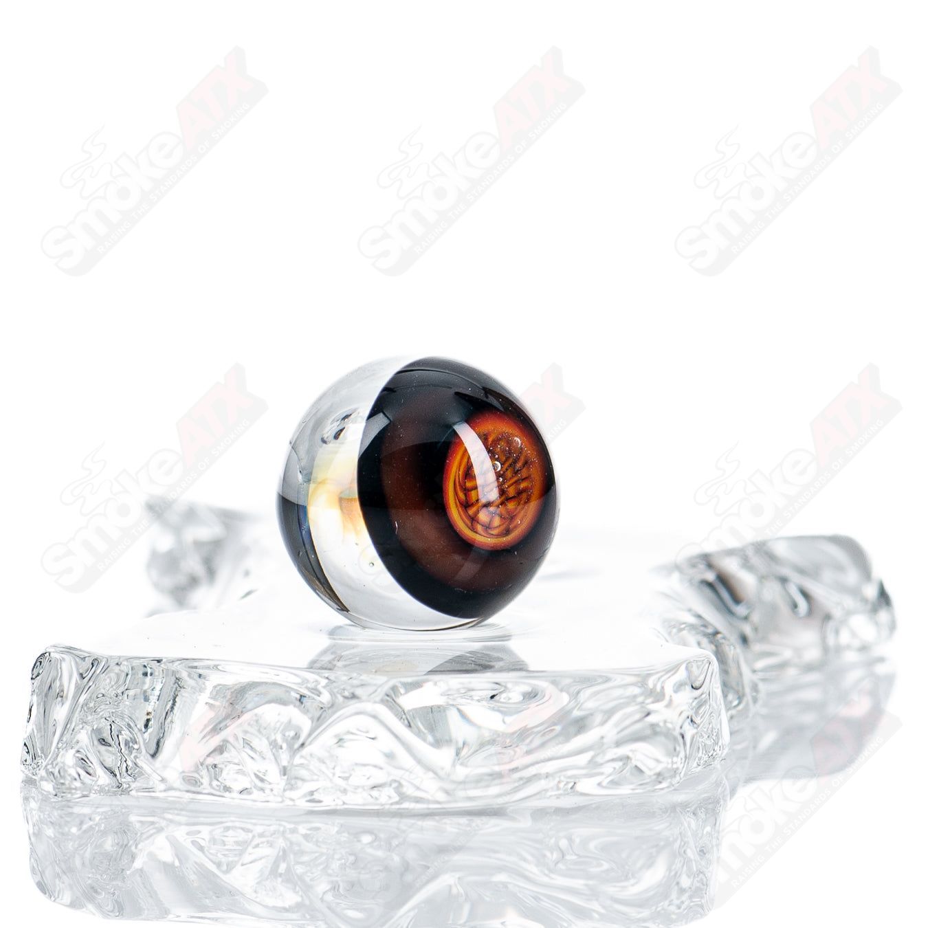 Two JMass heady glass Slurper marbles with intricate marble designs, showcasing vibrant colors and swirling patterns.