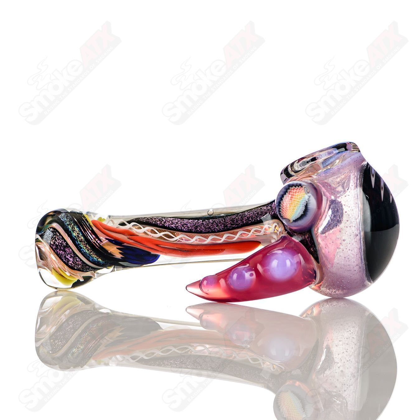 Colorfully worked IO spoon hand pipe by Jeremy from Oregon with vibrant 24-color design, made of heady glass.