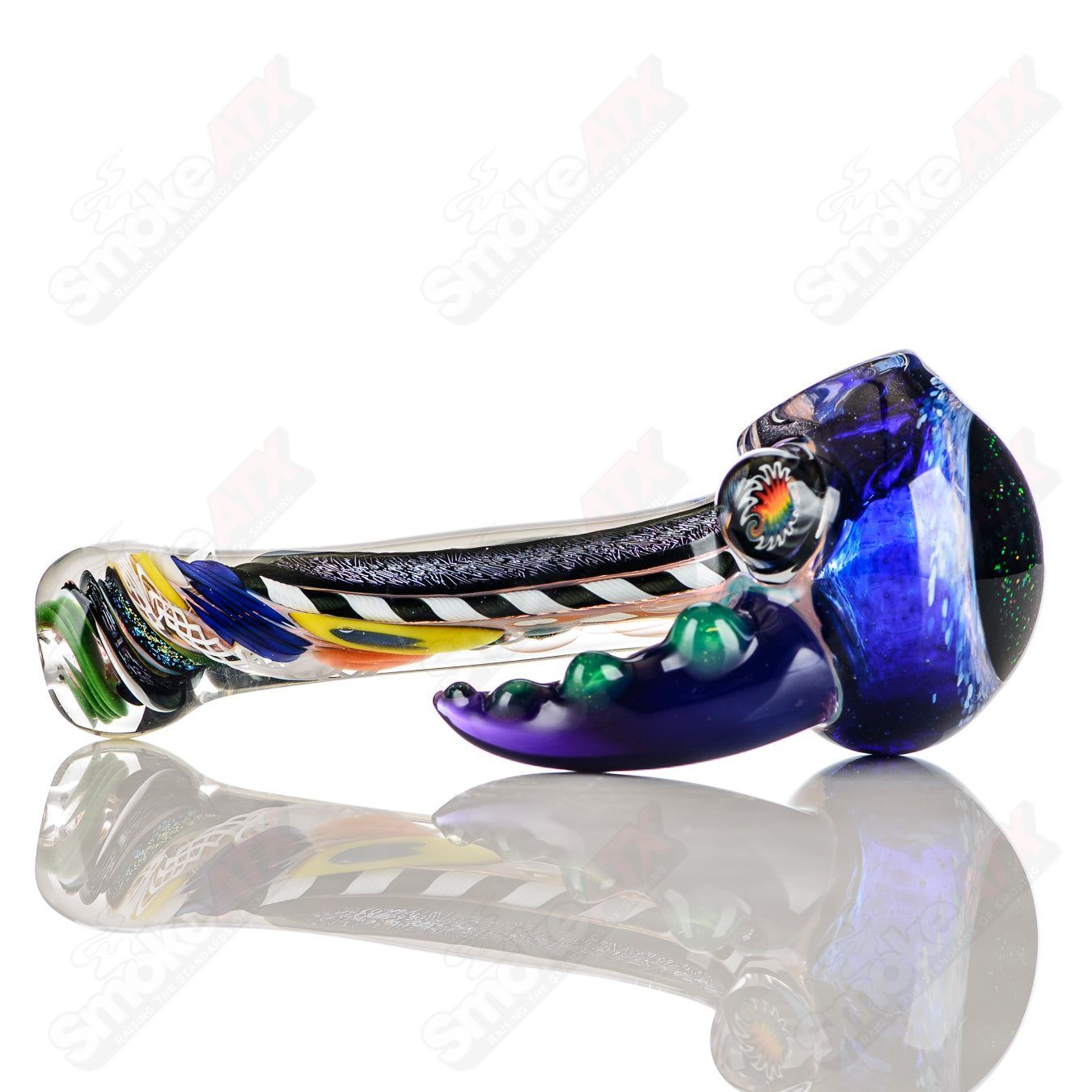 Color Worked IO Spoon hand pipe by Jeremy from Oregon featuring vibrant, intricate glasswork in a compact, easy-to-handle design.