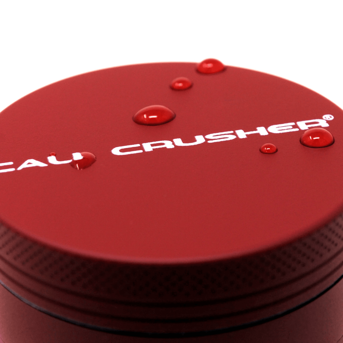 Red 2-inch Cali Crusher 4-piece hardtop metal grinder, designed for efficient grinding of herbs and spices.