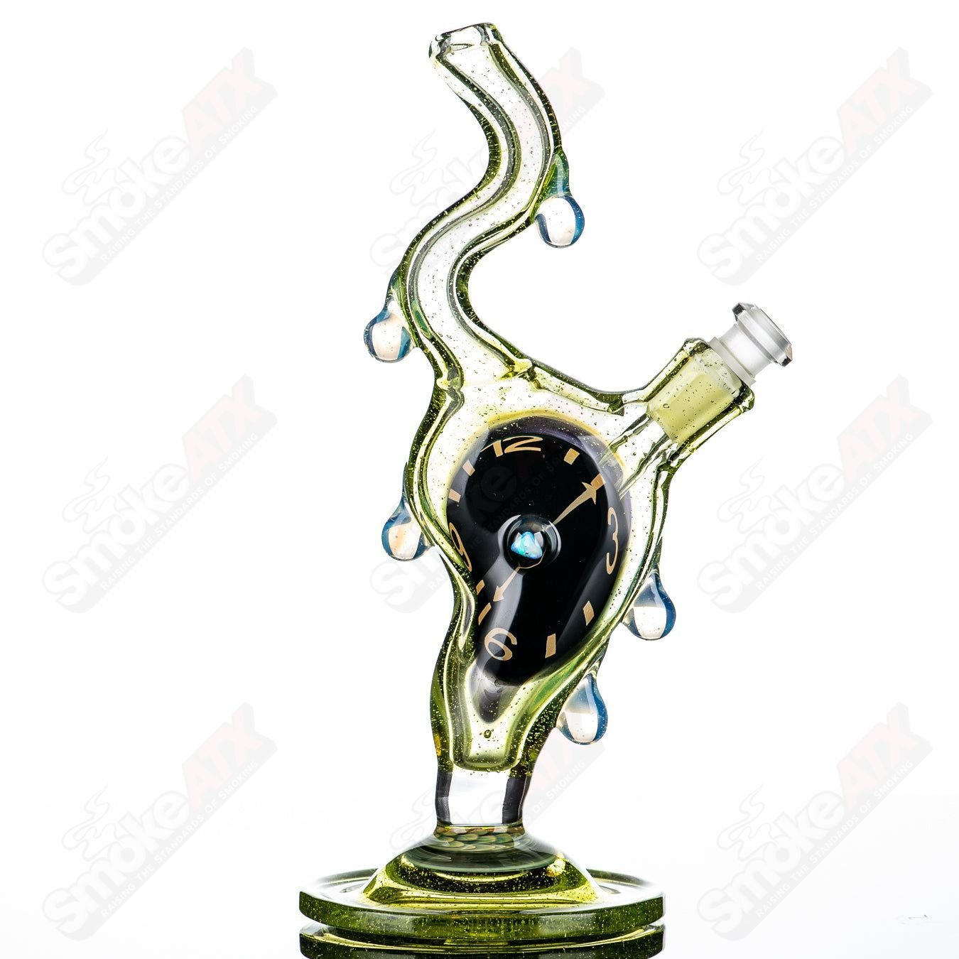 Scoby Dali Melting Clock rig with opal accent, clear heady glass concentrate rig designed by Scoby, featuring a surreal melting clock design.