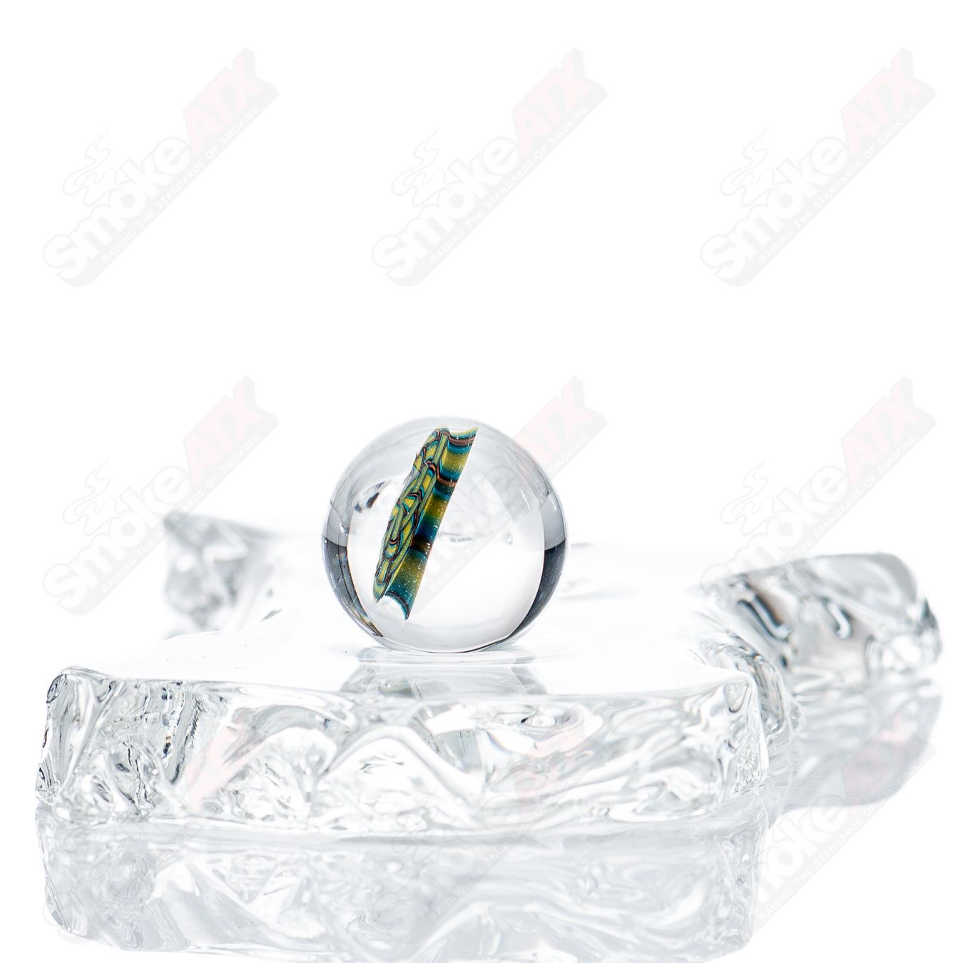 Heady glass marble with three slurper designs by JMass, featuring colorful, intricate patterns on a smooth, rounded surface.