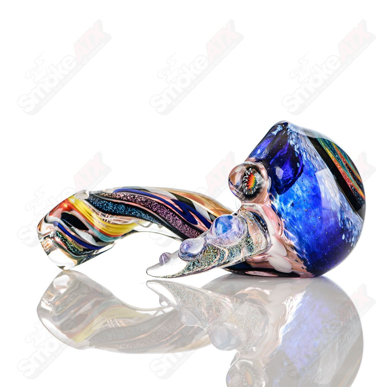 Colorfully worked IO spoon hand pipe by Jeremy from Oregon, featuring intricate 32-color design and smooth glass craftsmanship.