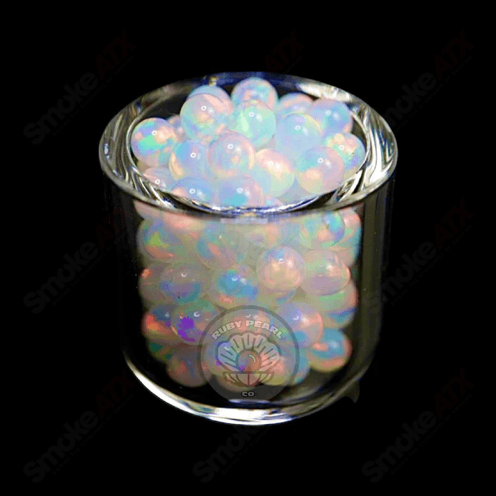 Three 3mm white opal pearls from Ruby Pearl Company, showcasing smooth, round pearls suitable for jewelry making.