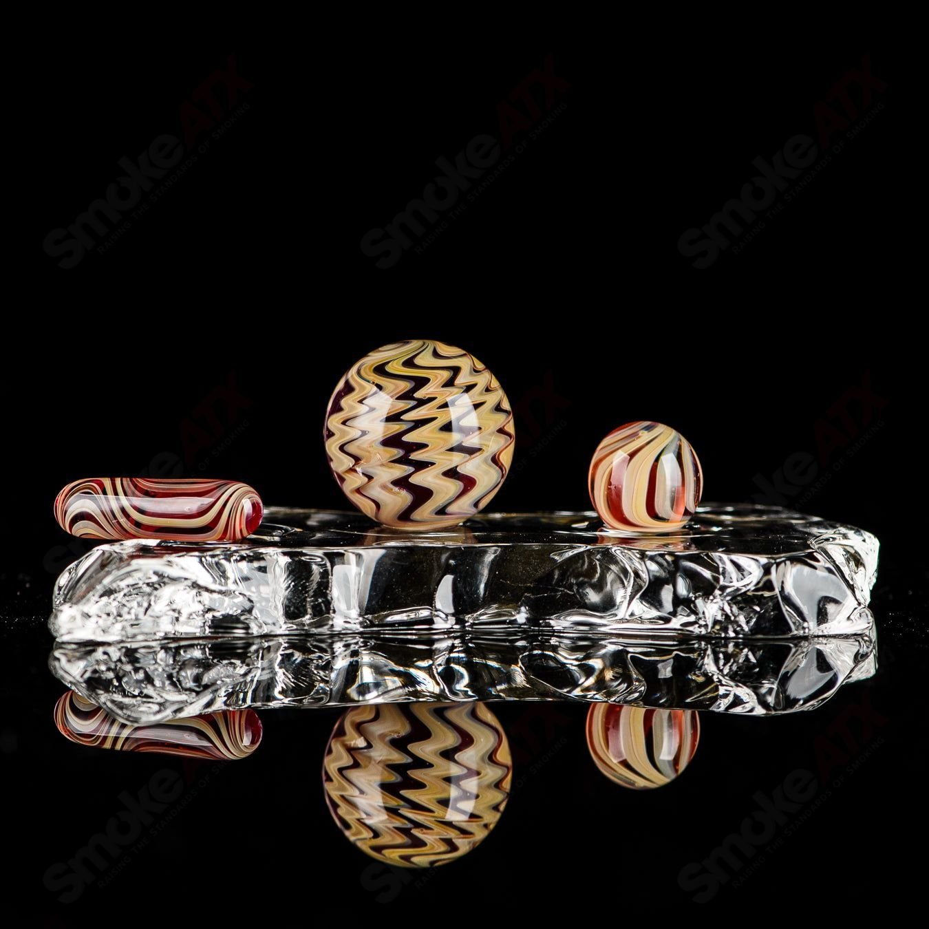 Set of three Indo Glass UV color worked slurpers in pomegranate, tan, and lava for glass accessories collection.