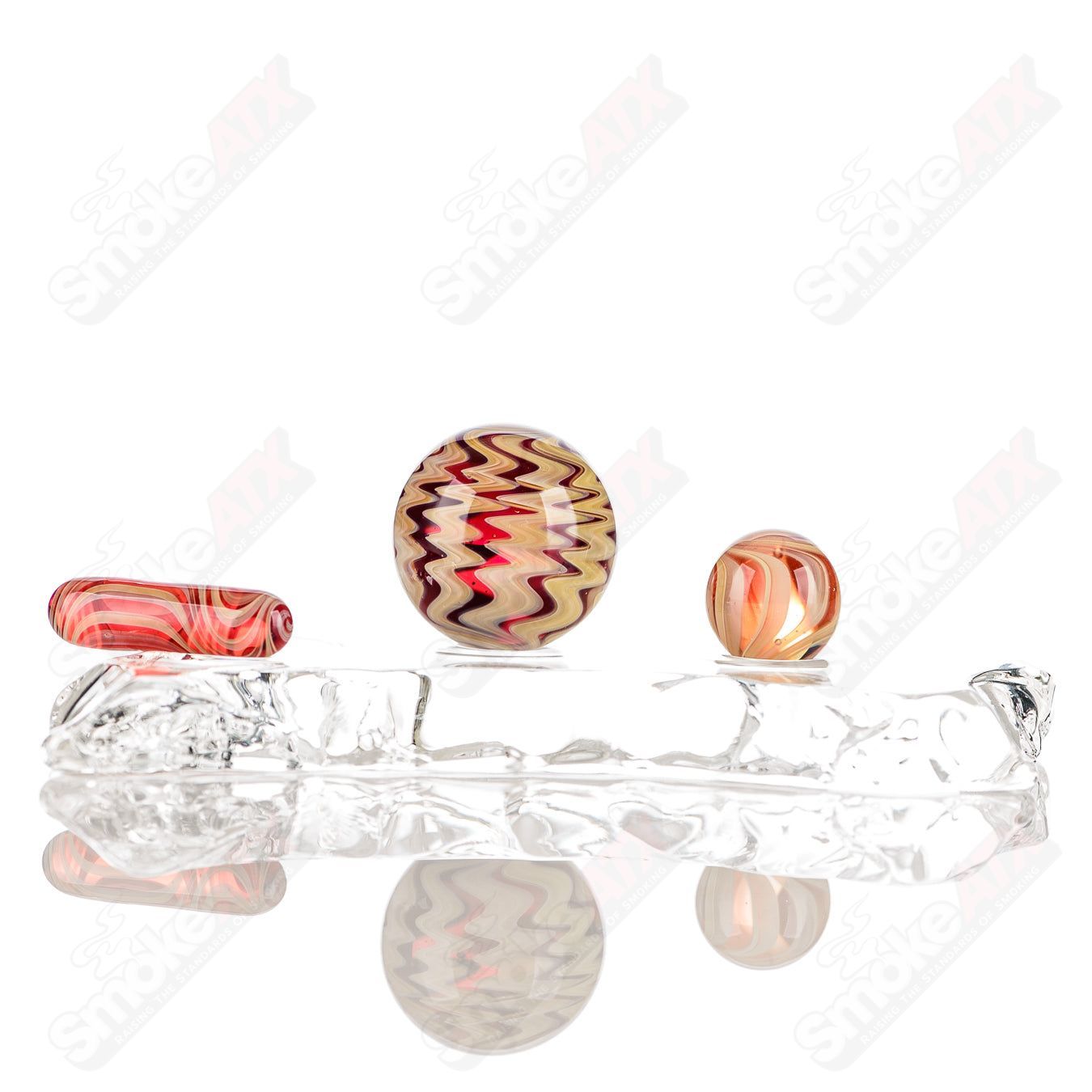 Set of three Indo Glass UV color worked slurpers in pomegranate, tan, and lava finishes for glass accessories.