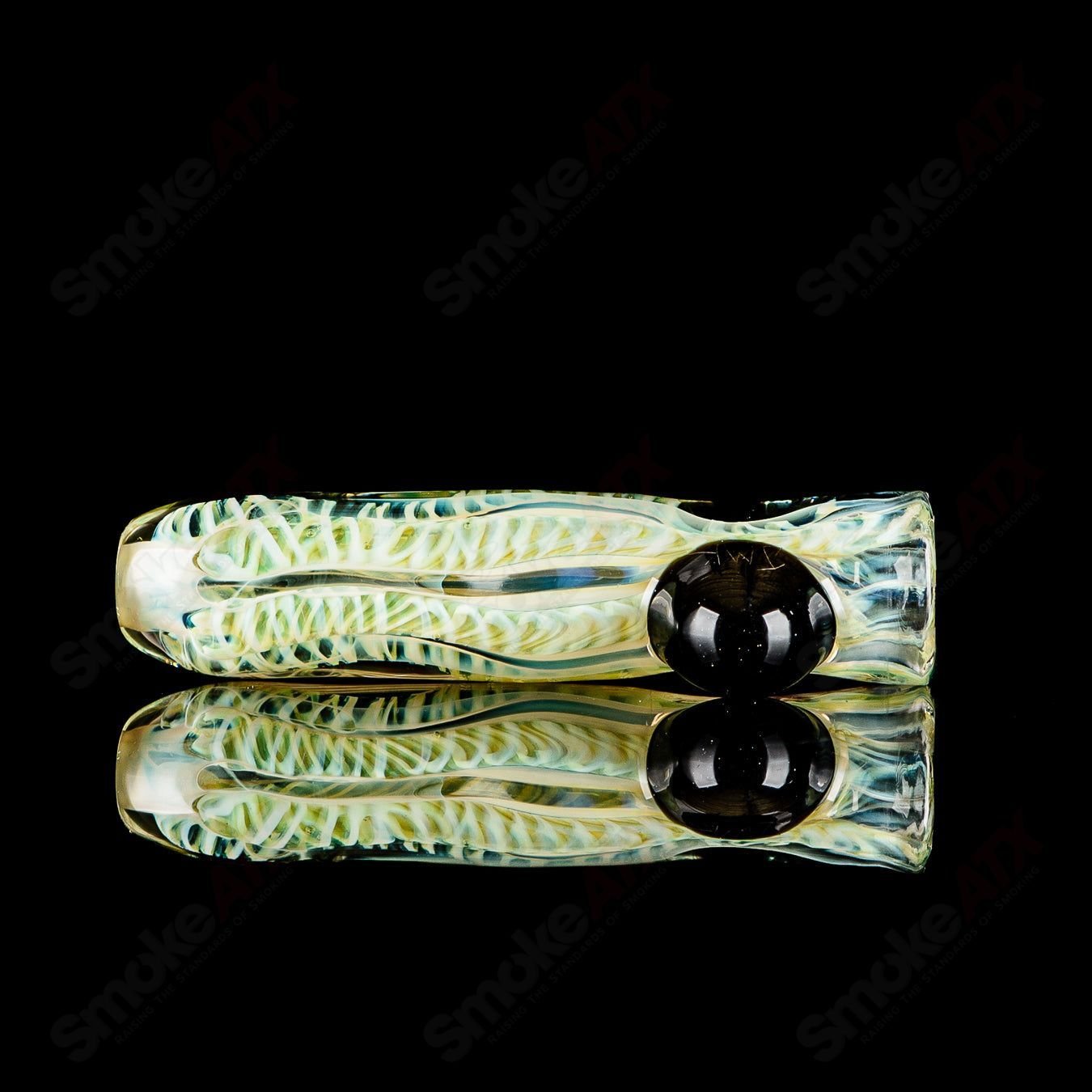 Handcrafted signed JMK Glass #5 I/O Worked Chillum made of clear glass with intricate worked details.