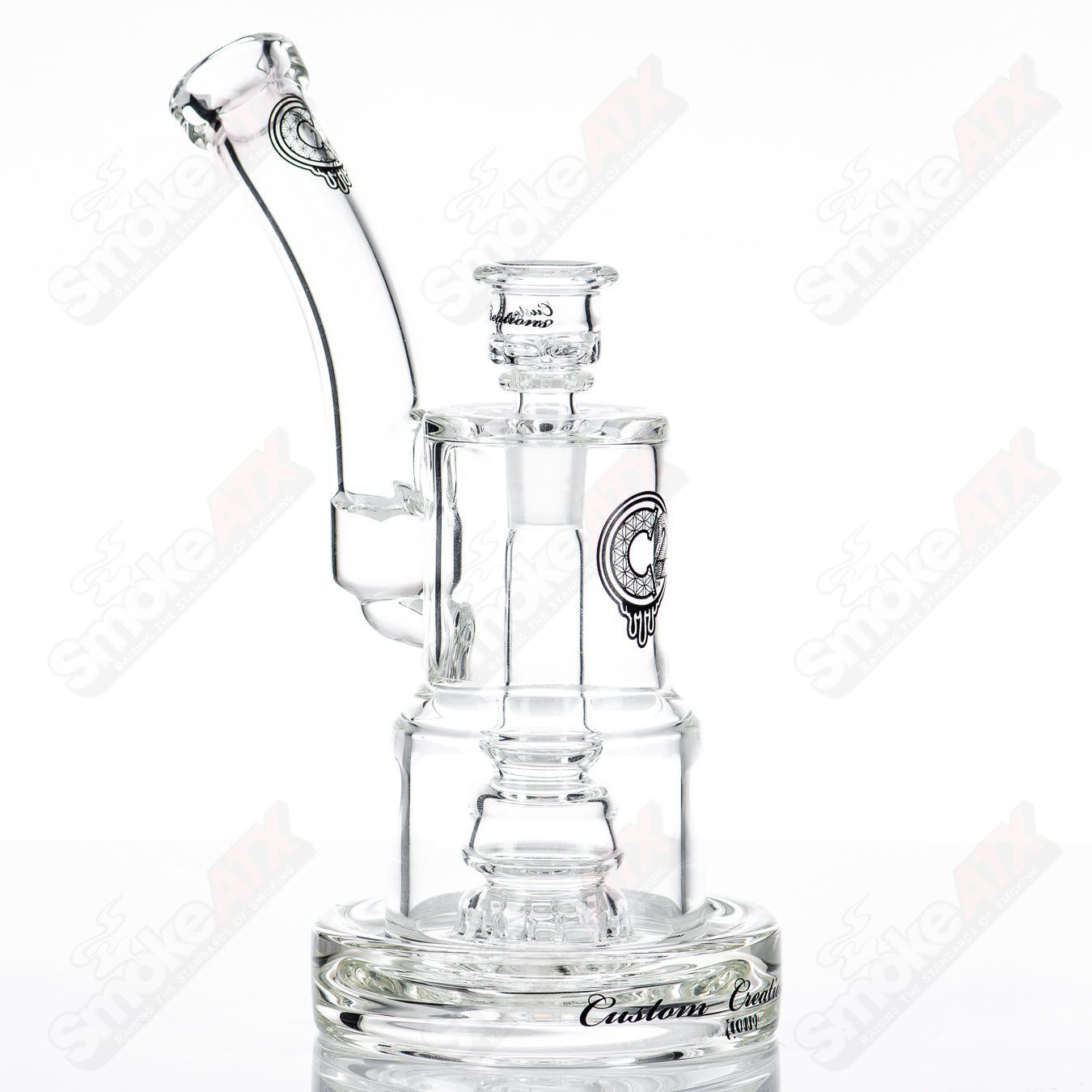 C2 Custom Creations glass waterpipe with 50mm to 80mm fixed sprocket perc bubble, featuring intricate design and clear glass construction.