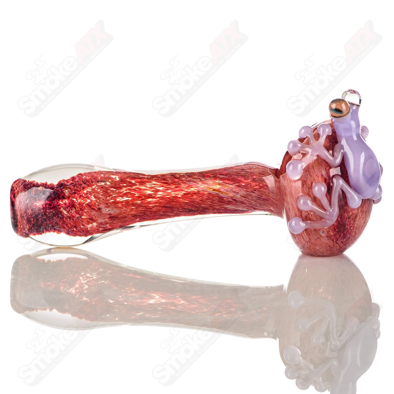Beezy Glass #6 Frog Spoon pipe made of clear glass with a frog design, featuring a smooth bowl and curved mouthpiece.