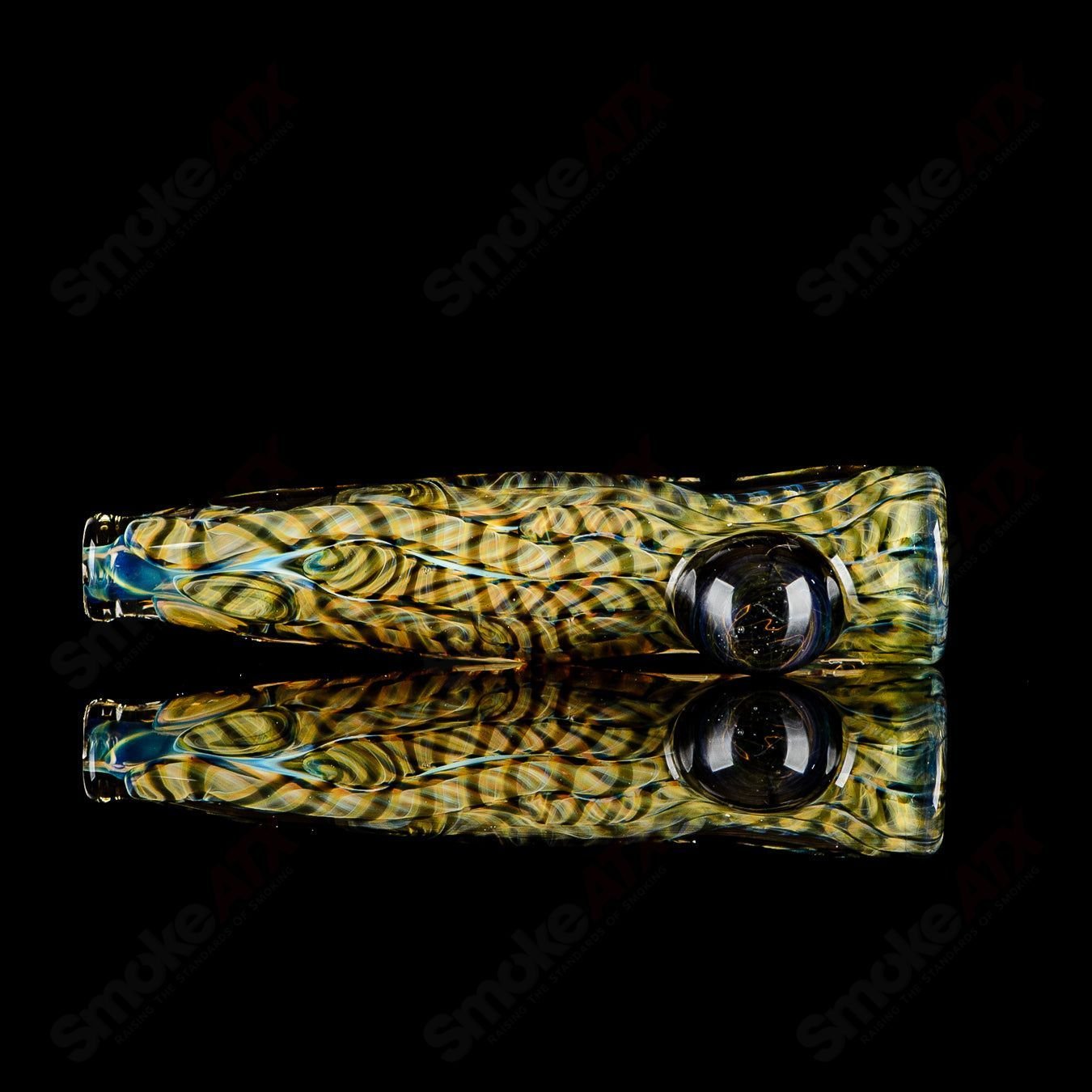 Handcrafted signed JMK Glass #6 I/O Worked Chillum made of clear glass with intricate worked details.