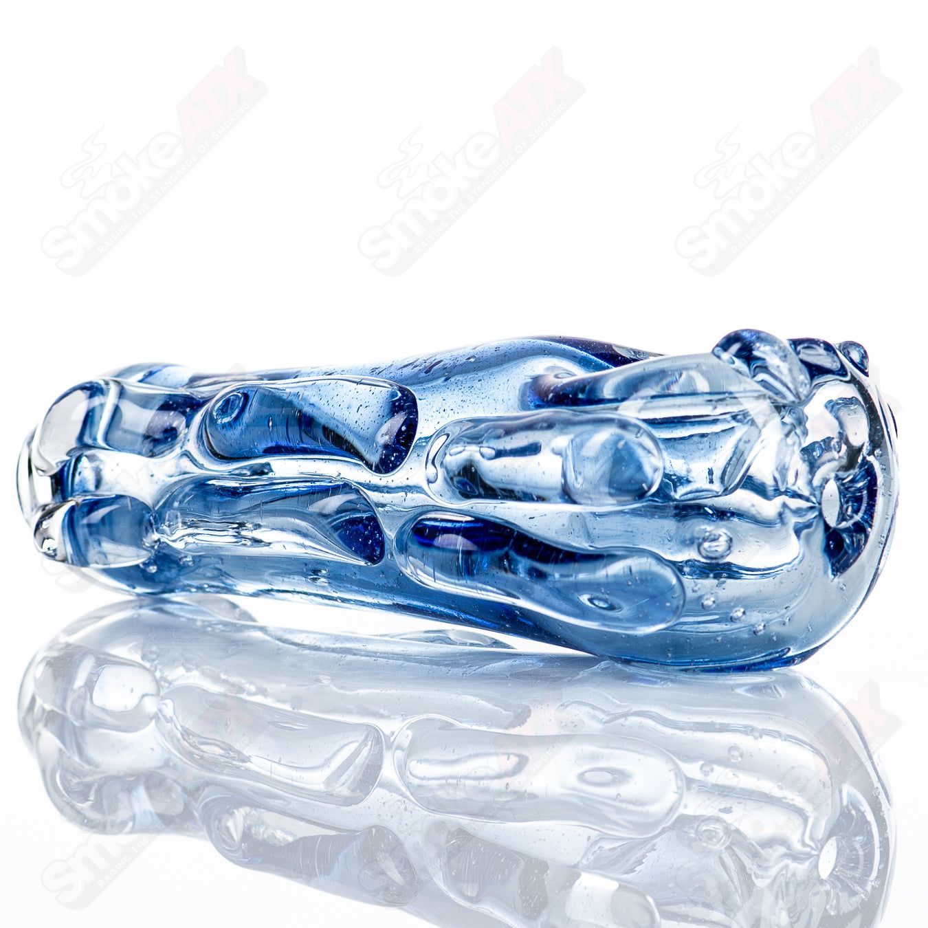 Glass pipe, #70 Spoon by Nobody, made of clear glass with a smooth bowl and curved mouthpiece, designed for smoking.