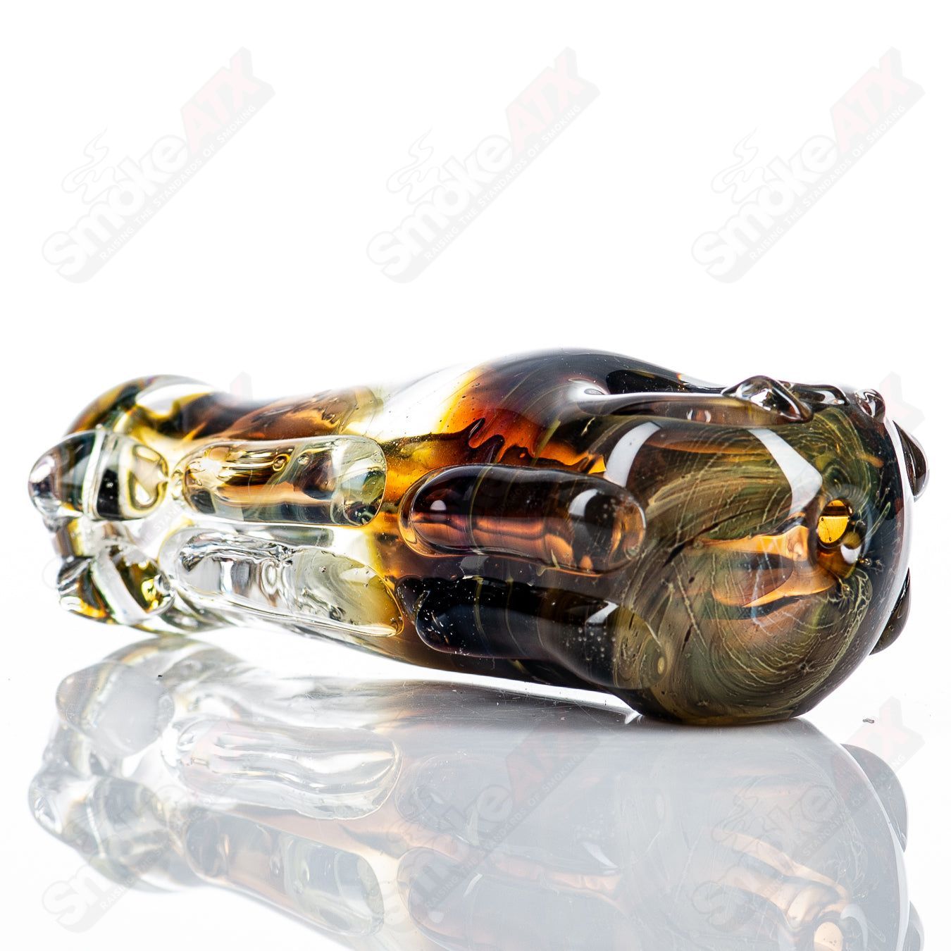 Glass pipe designed in a spoon shape by Nobody, featuring clear glass with colored accents and a smooth bowl for smoking.