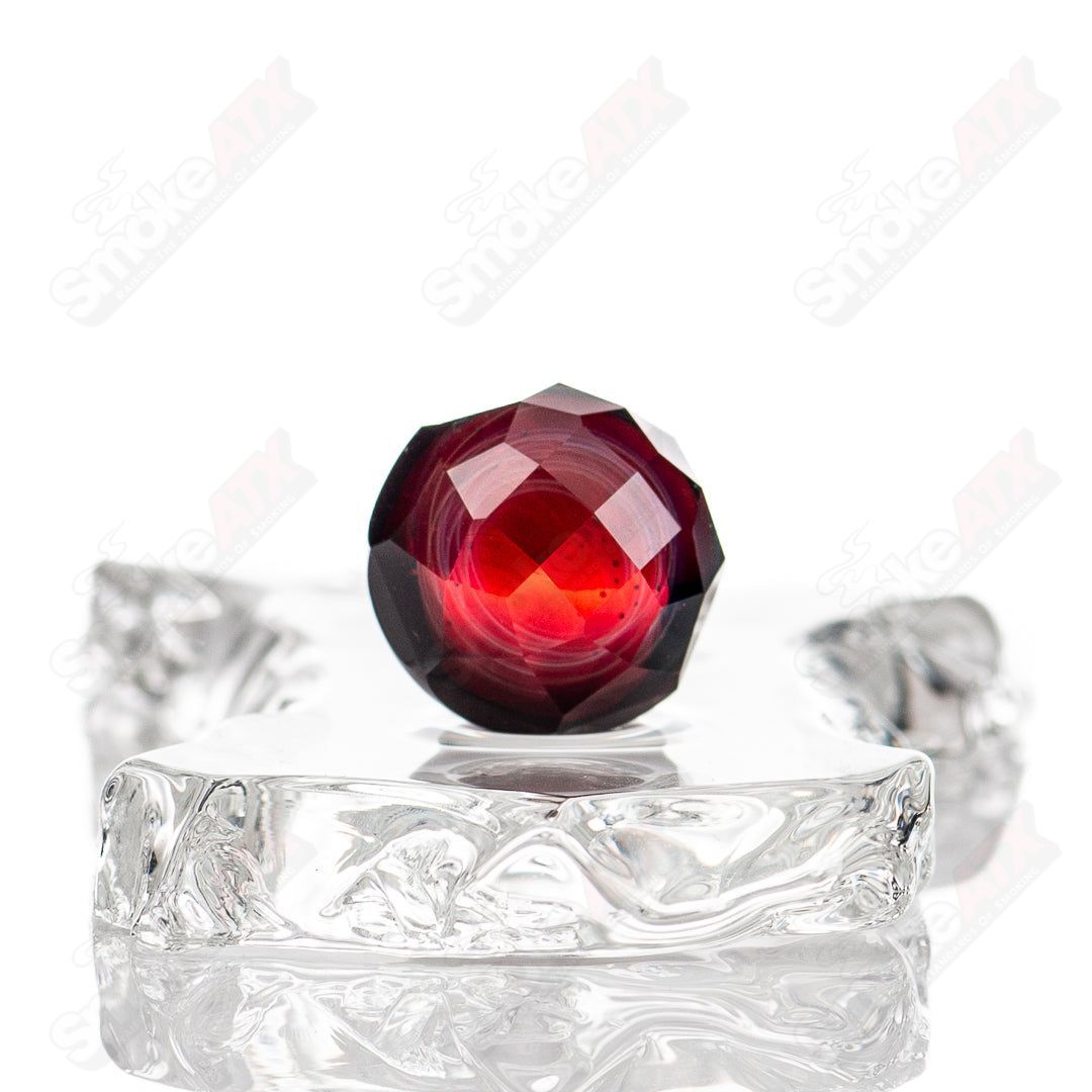 Faceted marble glass heady marble by Fatal Facets featuring colorful, faceted designs on a clear glass background.