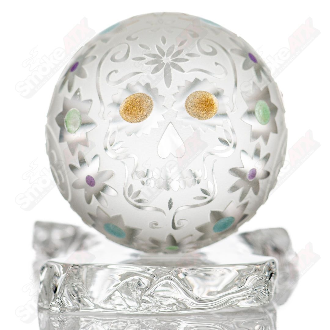 Faceted skull marble made of glass by Fatal Facets, showcasing intricate faceted design and smooth marble surface.