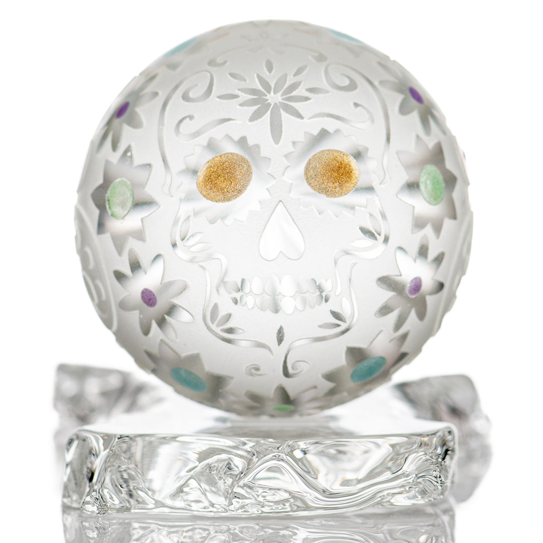 Faceted skull marble made of glass by Fatal Facets, showcasing intricate faceted design and smooth marble surface.