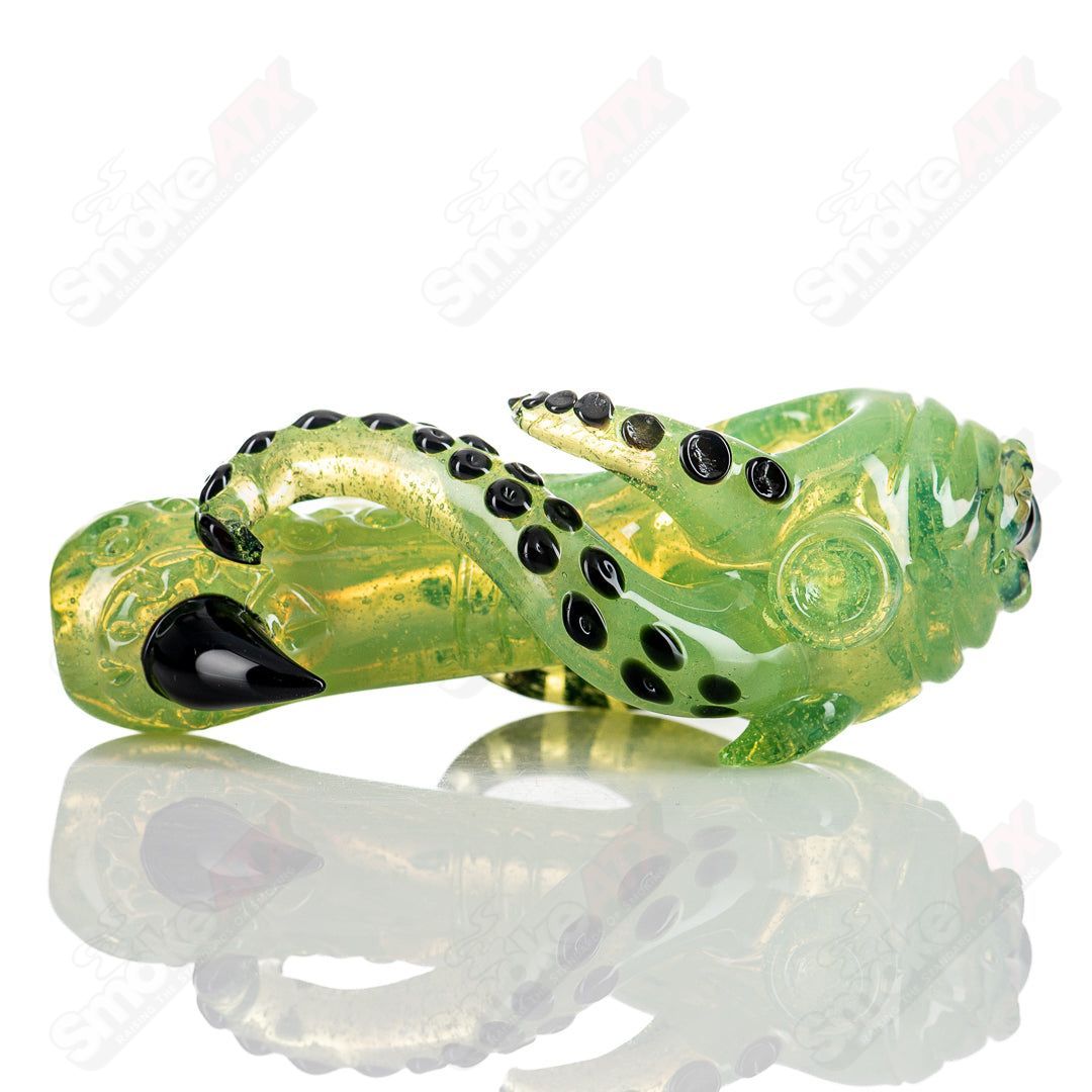 Mako Glass Seamonster Spoon hand pipe with colorful glass design, detailed sea monster theme, clear bowl and textured surface.