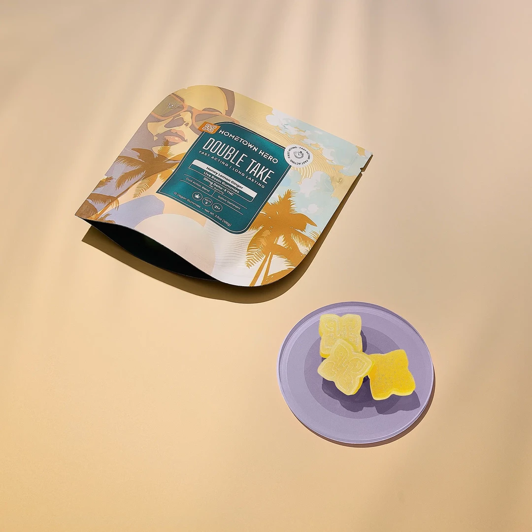 Hometown Hero Honey Lemon Ginger Delta-9 live rosin gummies in a clear container, showcasing the colorful edibles inside.