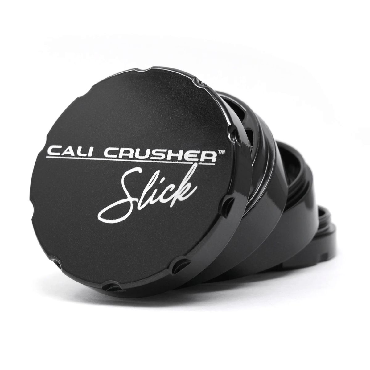 Black Cali Crusher 2.5-inch 4-piece metal grinder with Slick 420 Products branding, featuring textured grip and sharp grinding teeth.