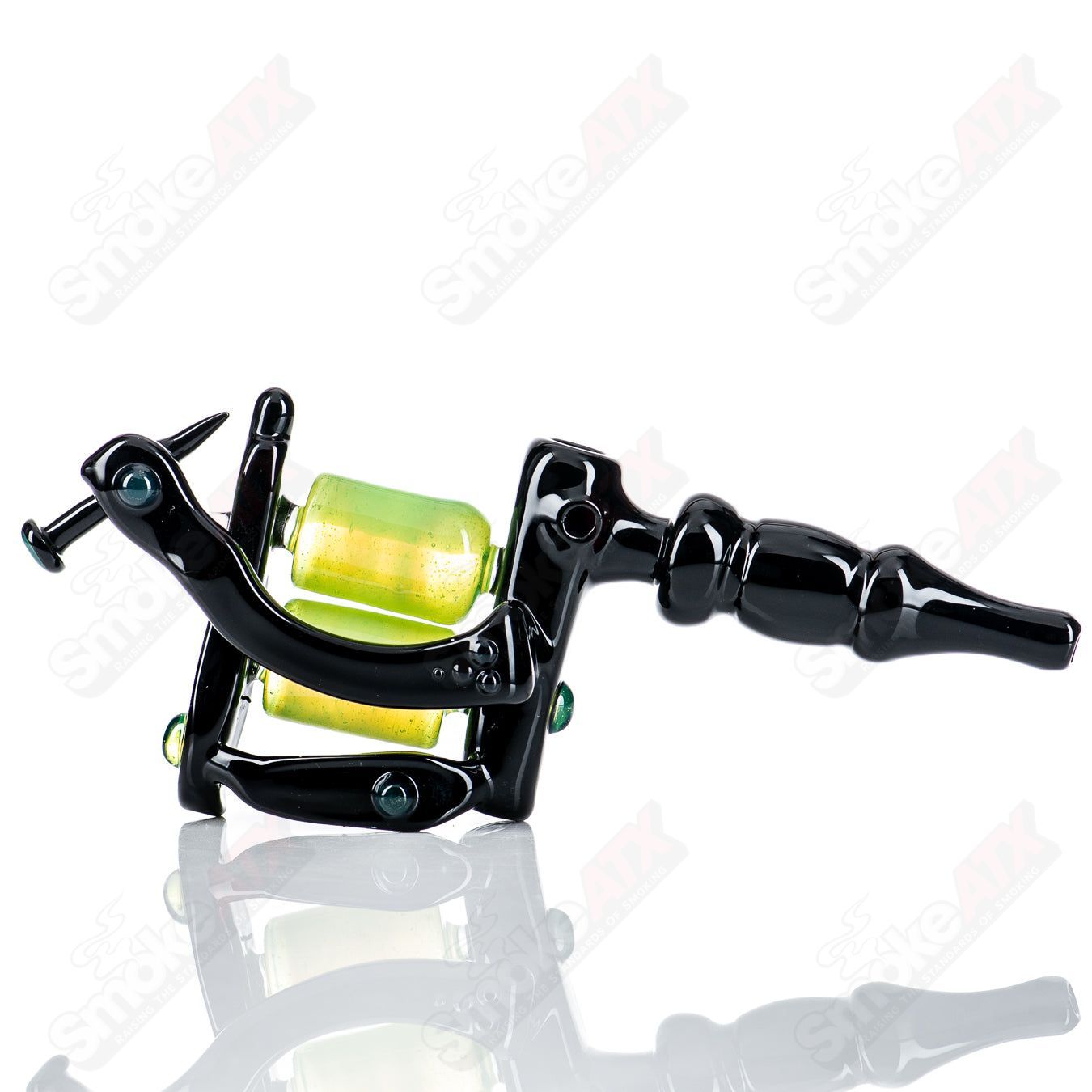 Black and slime-colored tattoo gun-shaped concentrate rig by JMass, featuring detailed glass art and intricate design.