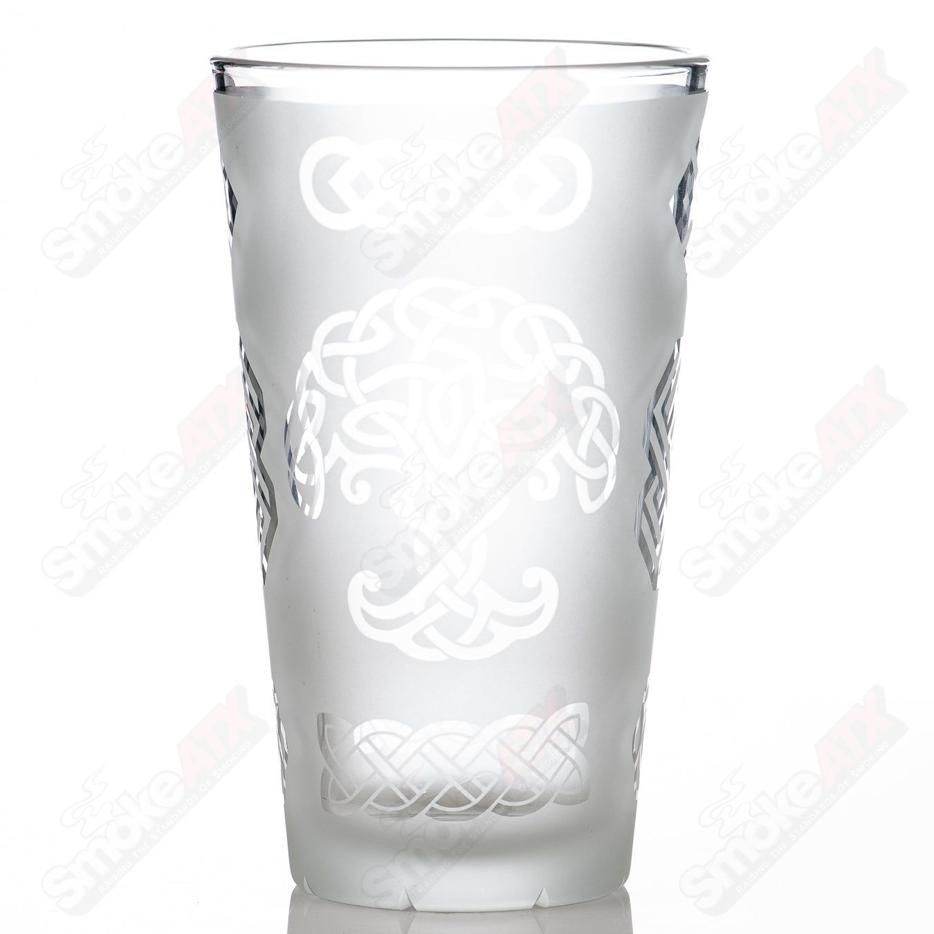Heady glass pint glass with blasted ancient patterns and intricate Fatal Facets design, featuring detailed textured surface.