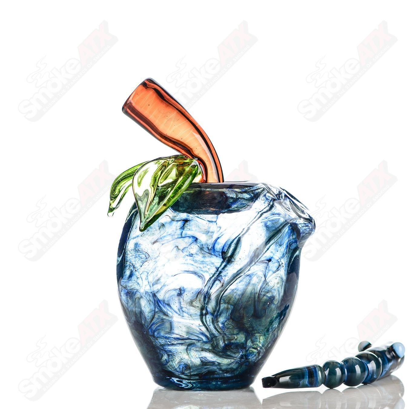 Blue apple-shaped concentrate rig with worm dabber and pouch, made of glass by Pouch Glass, designed for dabbing concentrates.