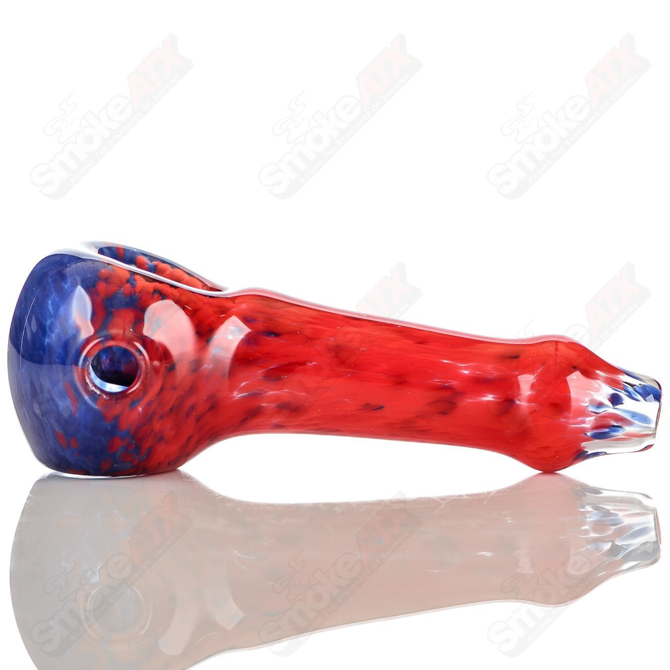 Signed blue and red frit glass spoon pipe by JMK Glass, showcasing intricate colorful glass art and craftsmanship.