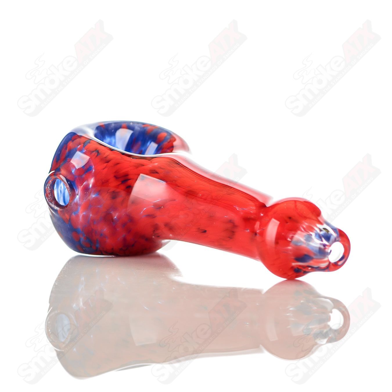 Signed JMK Glass blue and red frit glass spoon pipe with intricate color details and craftsmanship.