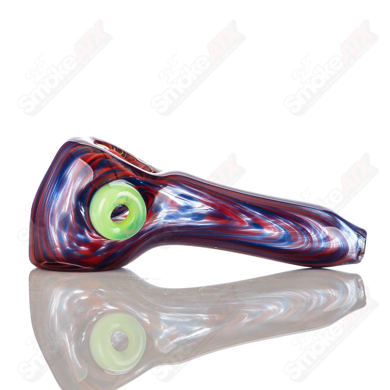 Blue and red worked glass spoon pipe with slyme accent and carved signature by JMK Glass, showcasing intricate craftsmanship.
