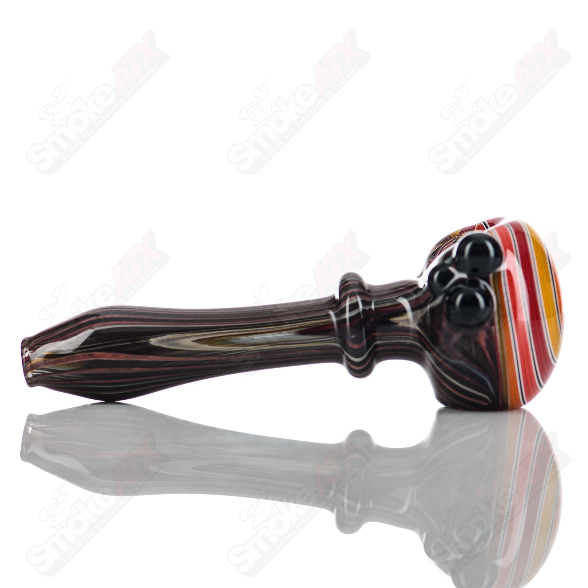Glass pipe with wood grain spiral cap, designed by Mtn Life Glass, featuring a smooth, clear glass body and decorative spiral cap.
