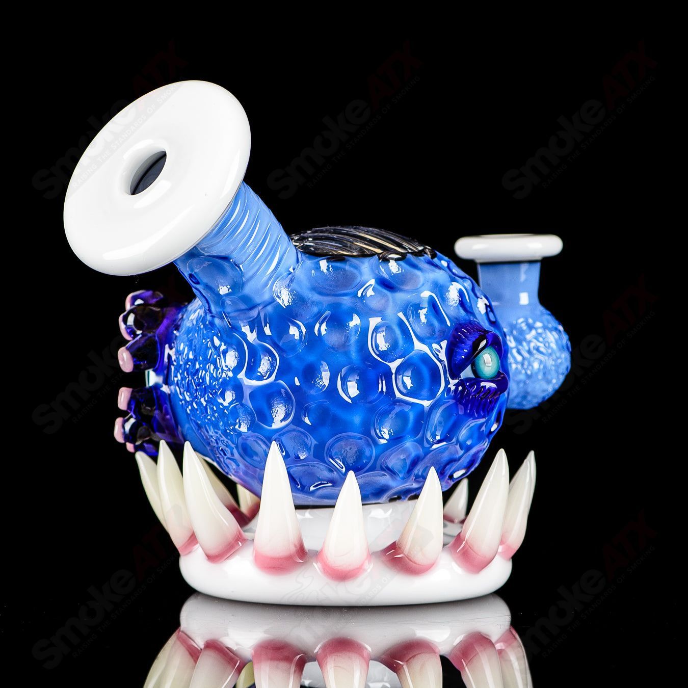 Brilliant blue orb rig by Salt & JAG, a glass concentrate rig with a spherical design and vibrant blue color.