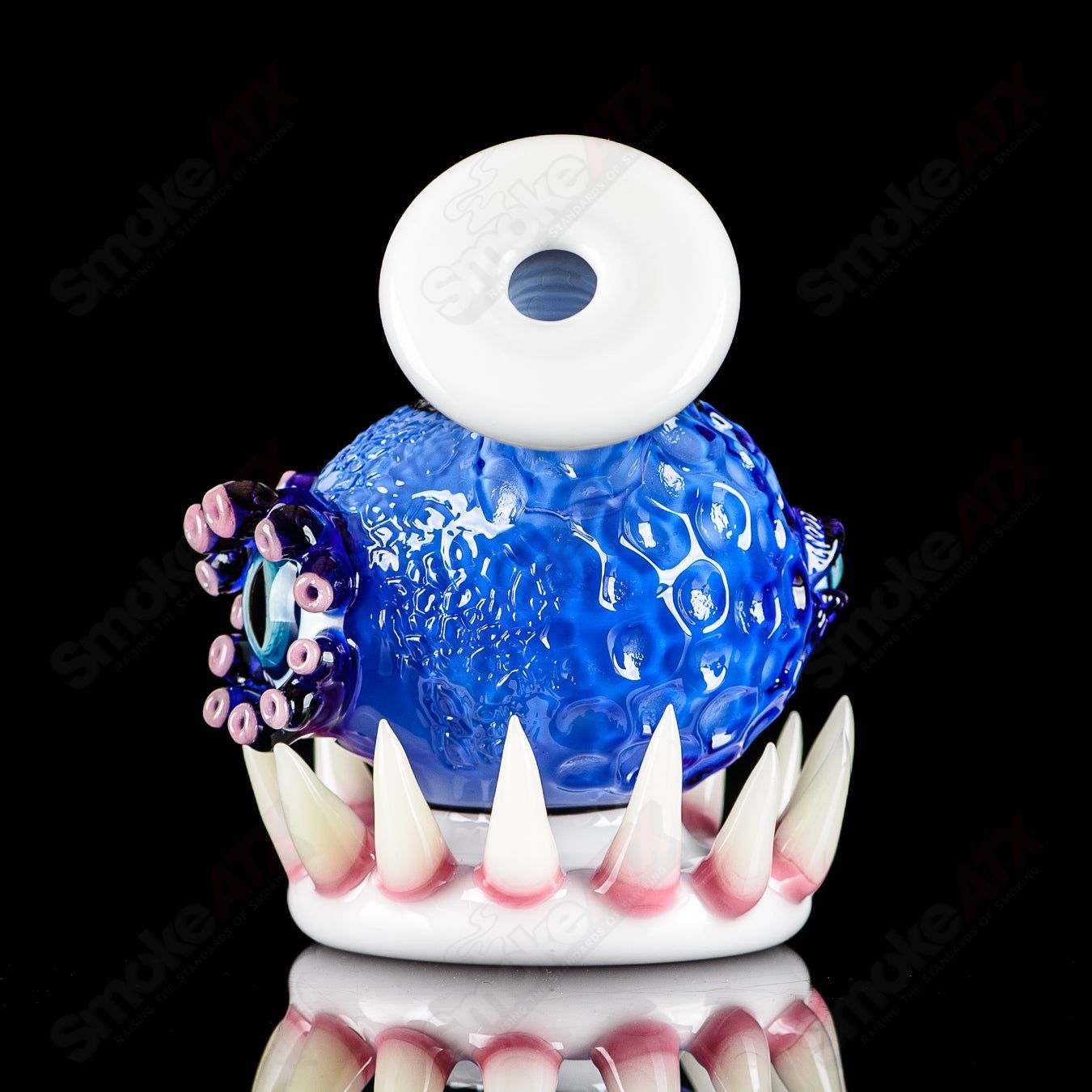 Brilliant blue orb-shaped concentrate rig by SALT & JAG, made of heady glass with intricate design and smooth finish.