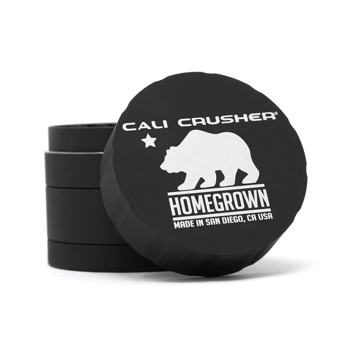 Cali Crusher 4-piece Homegrown black metal grinder with sharp teeth and pollen catcher for grinding herbs and cannabis.