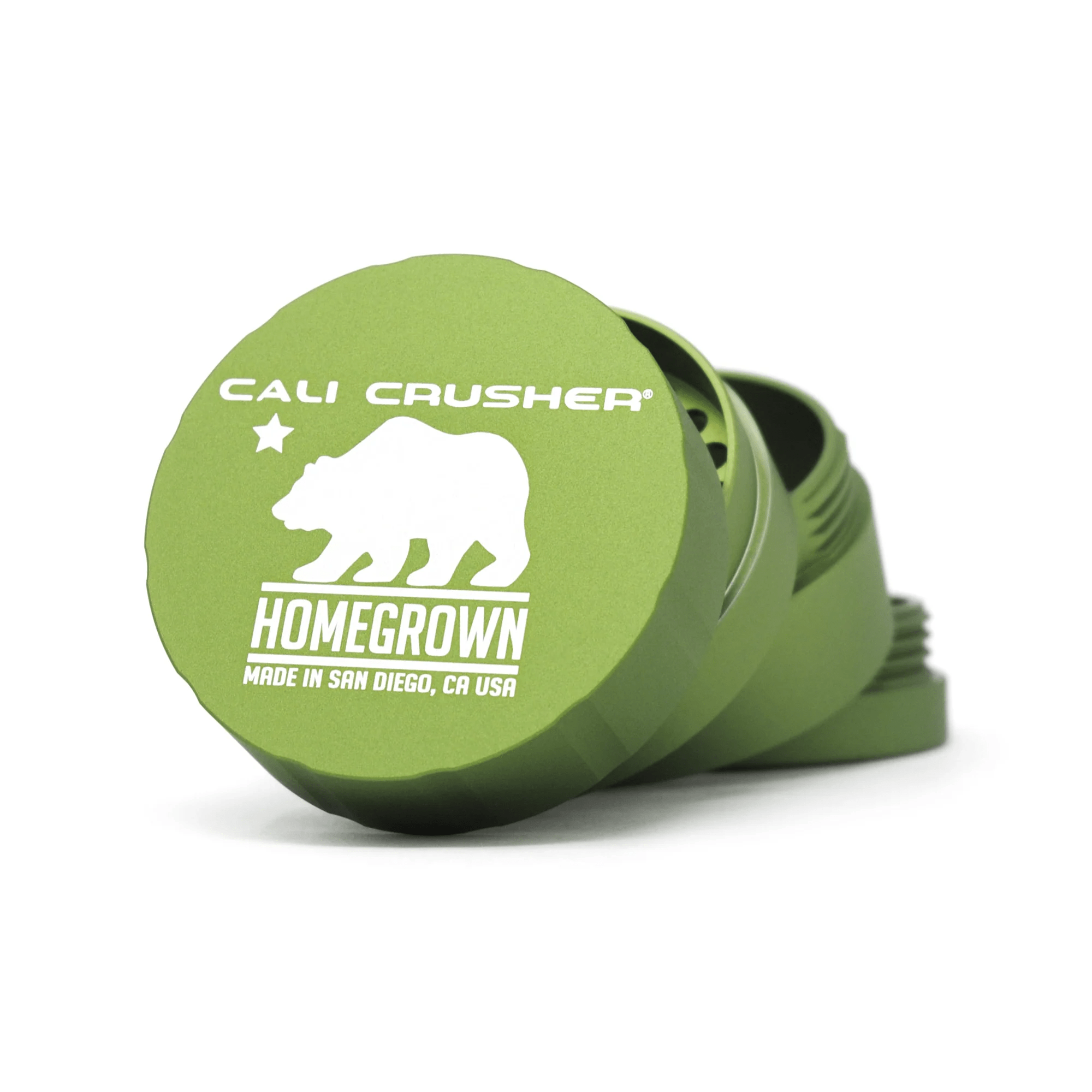 Cali Crusher 4-piece Homegrown Green metal grinder with sharp teeth and pollen catcher, designed for grinding herbs and flowers.