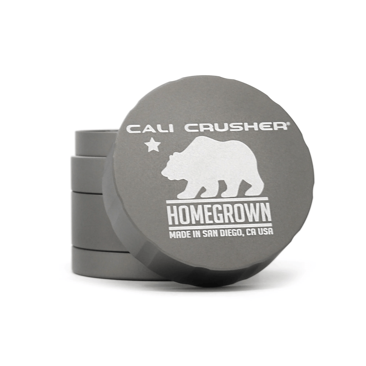 Cali Crusher 4-piece Homegrown Grey metal grinder with textured grip and multiple compartments for grinding herbs and storage.