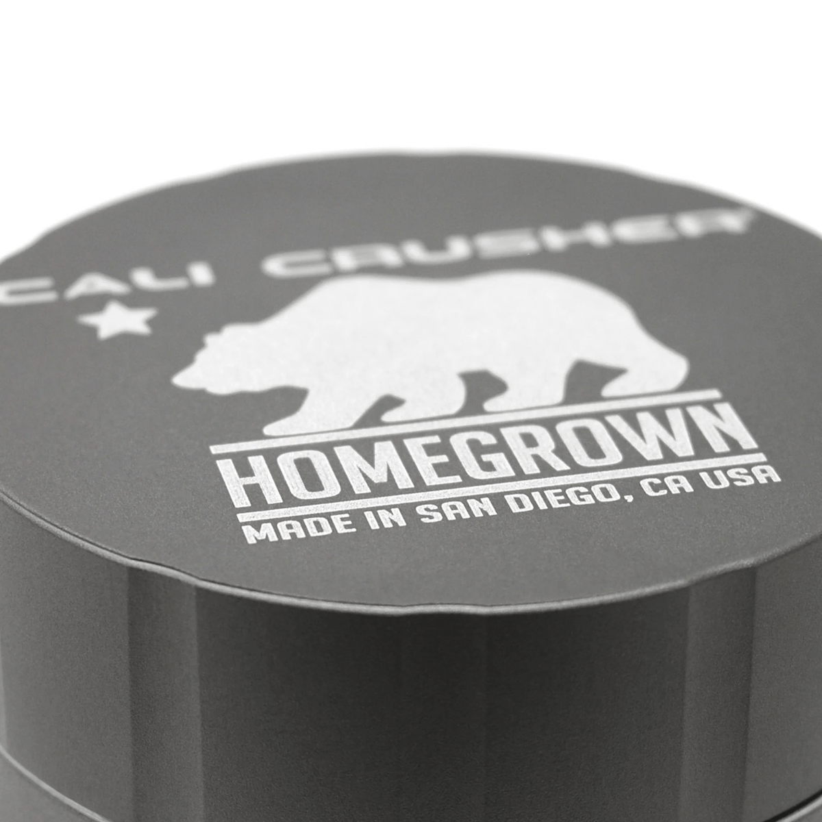 Cali Crusher 4-piece Homegrown Grey metal grinder with textured grip and multiple chambers for grinding herbs efficiently.