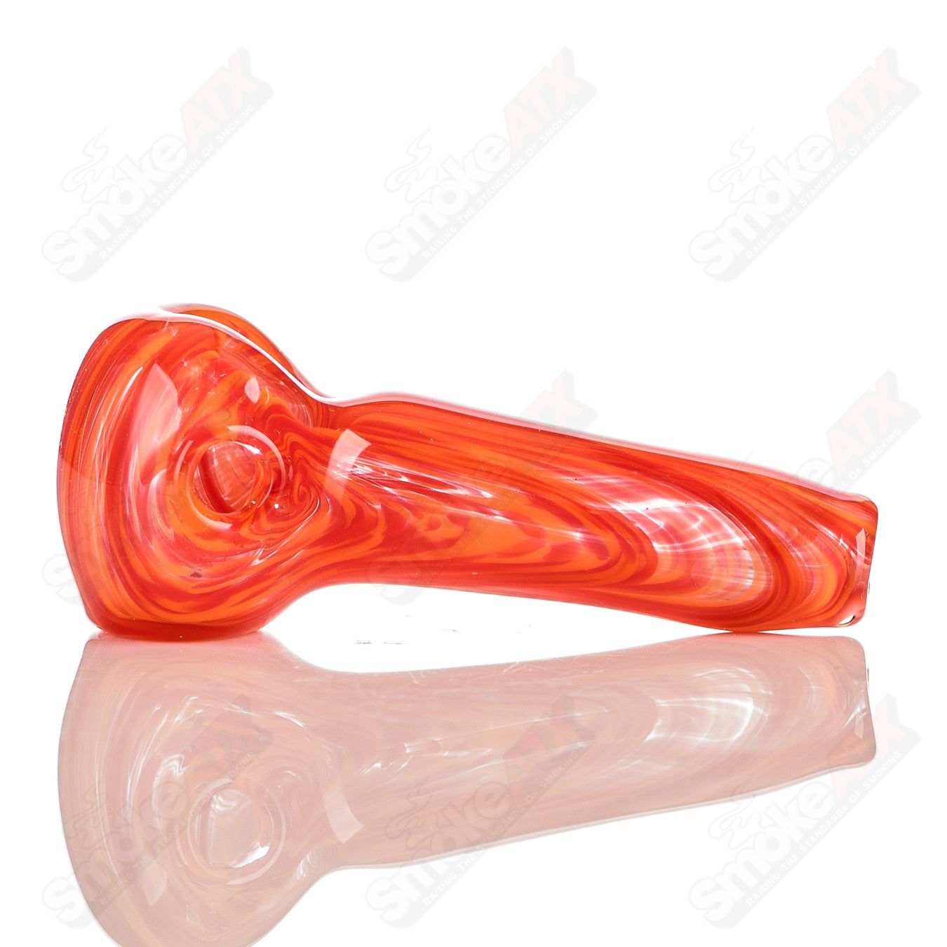 Color worked red and orange glass spoon pipe signed by JMK Glass, featuring vibrant, intricate glass artistry.