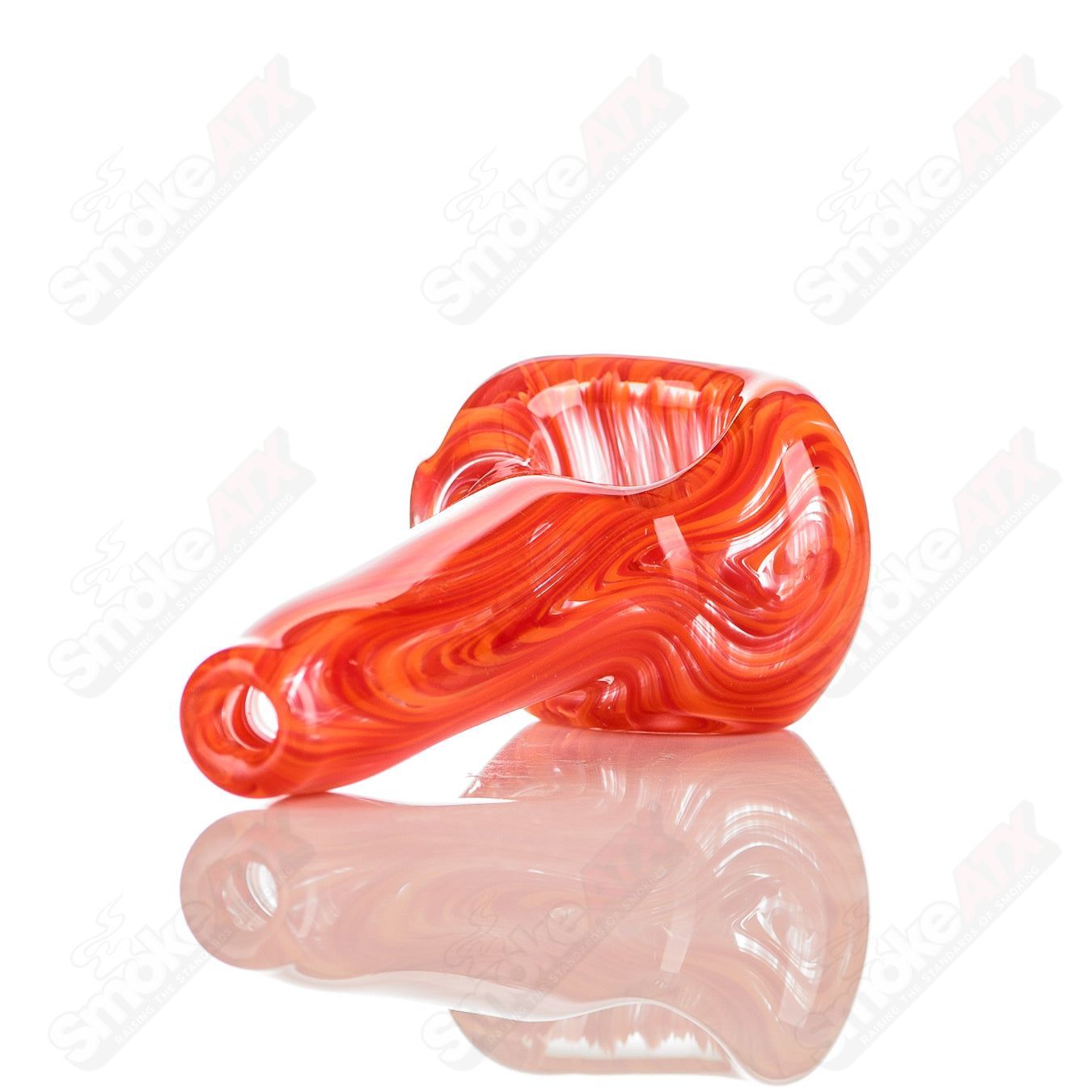 Red and orange color-worked glass spoon pipe signed by JMK Glass, featuring intricate design and smooth glass finish.