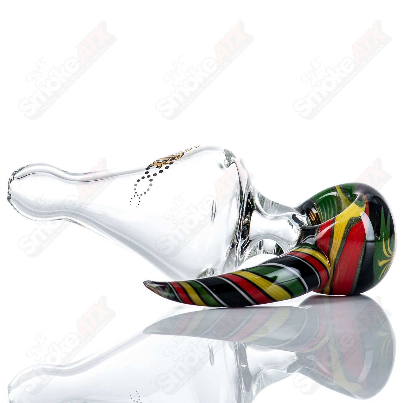 Custom Rasta medium helix glass spoon pipe by Smoke ATX featuring vibrant colors and intricate spiral design.
